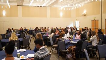 Attendees sitting at round tables for the One health Symposium