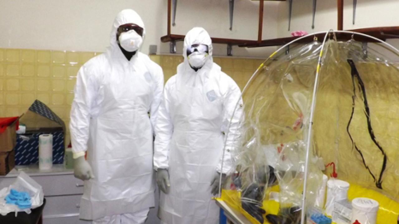 Two lab researchers in protective gear