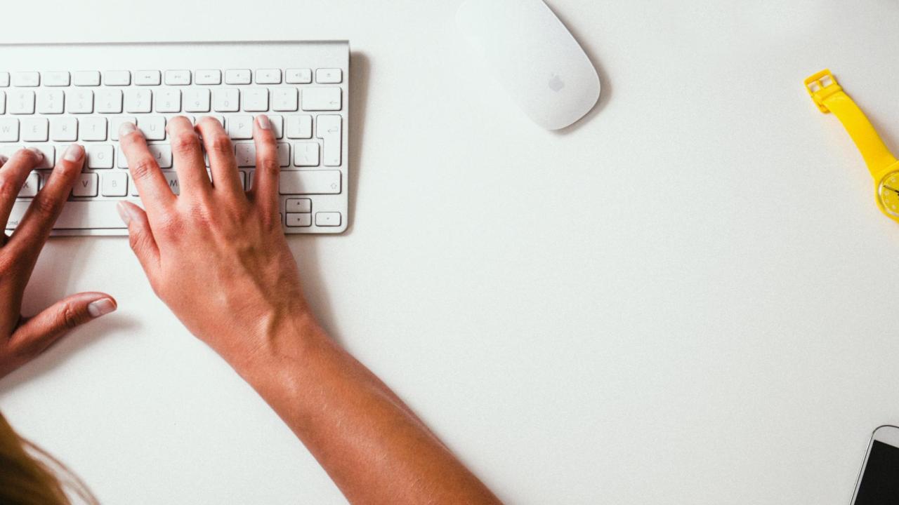 hands typing on a keyboard