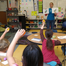 Dr. Deborah Thomson explaining One Health to elementary students in a classroom.