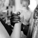 black and white photo of hands clasped together