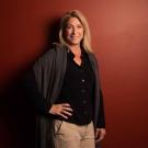 Christine Kreuder Johnson standing in front of a red wall